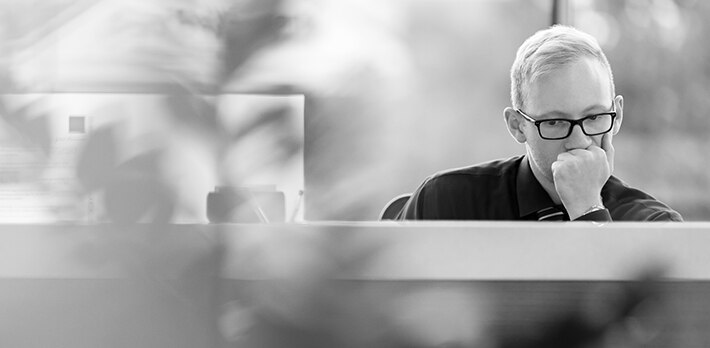 Man sitting at a desk thinking