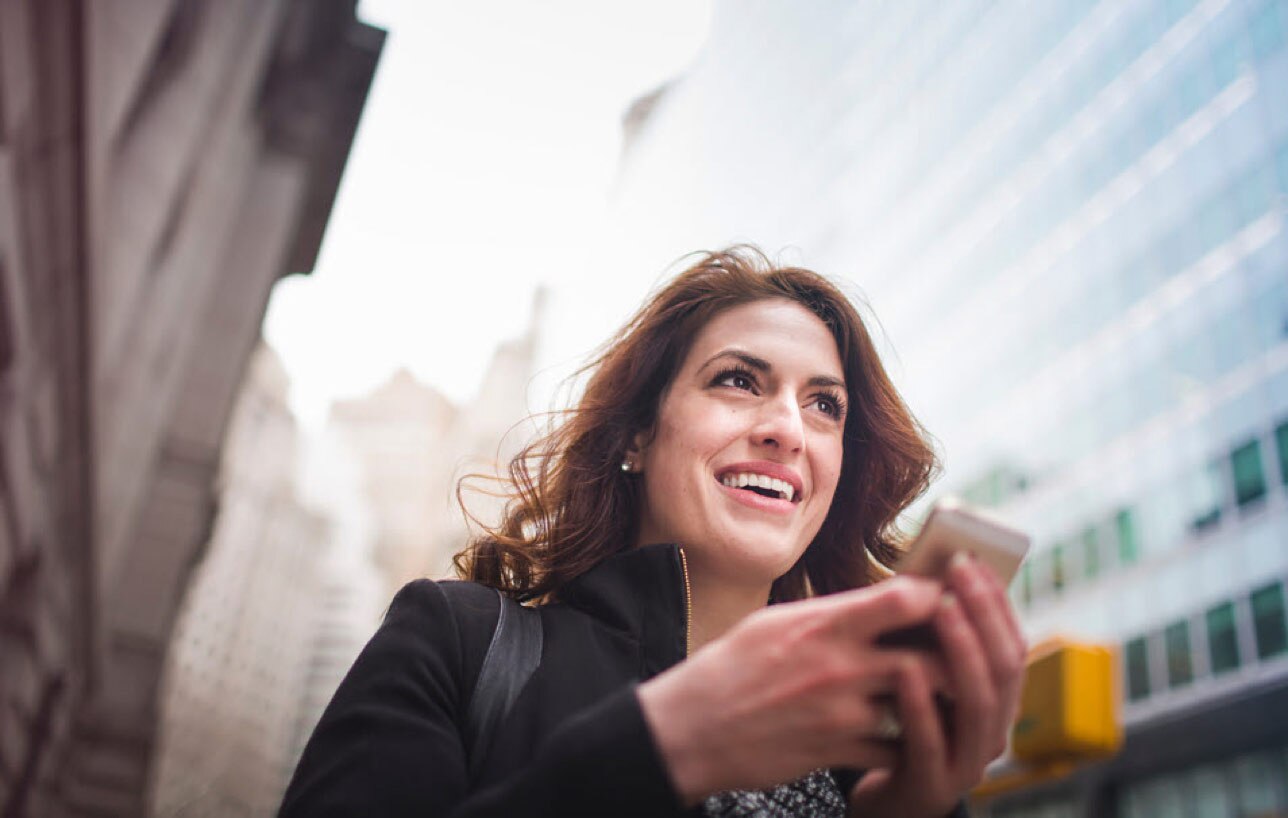 A client uses her smartphone to connect to her investment advisor.