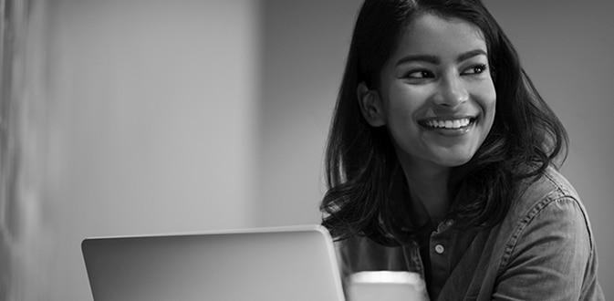 Smiling woman using her laptop