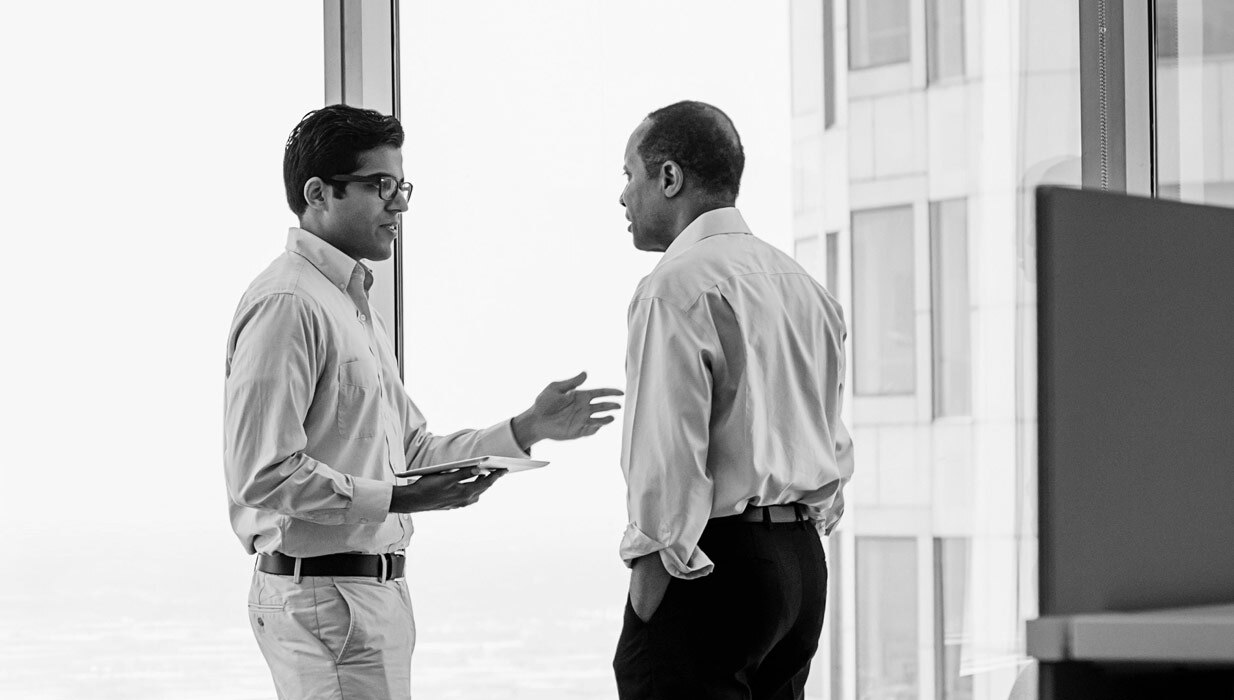 Two investment advisors discuss their business model.