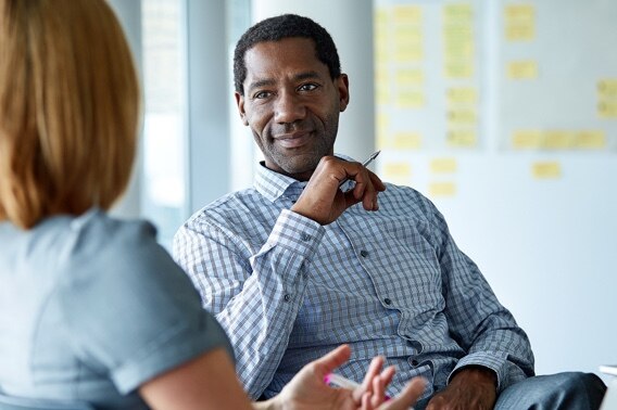 An investment advisor strategizes with a colleague. 