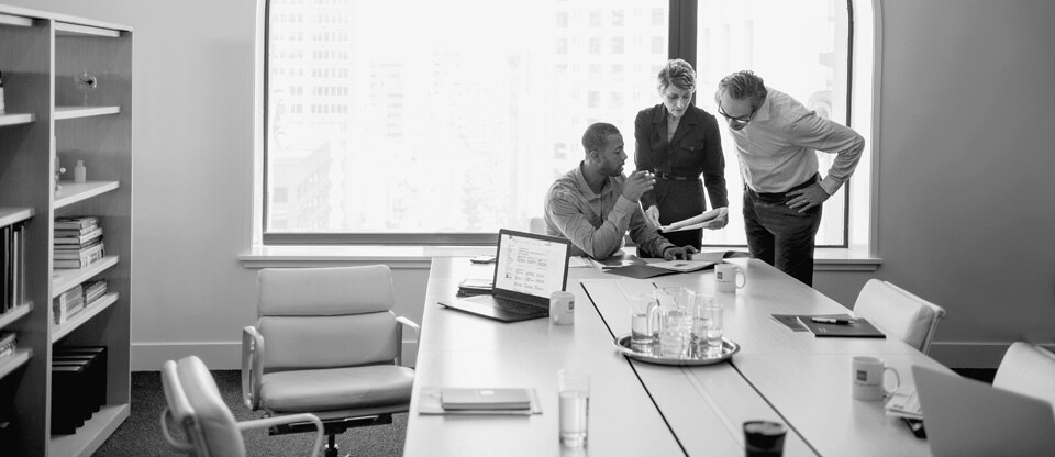 Three people looking at documents
